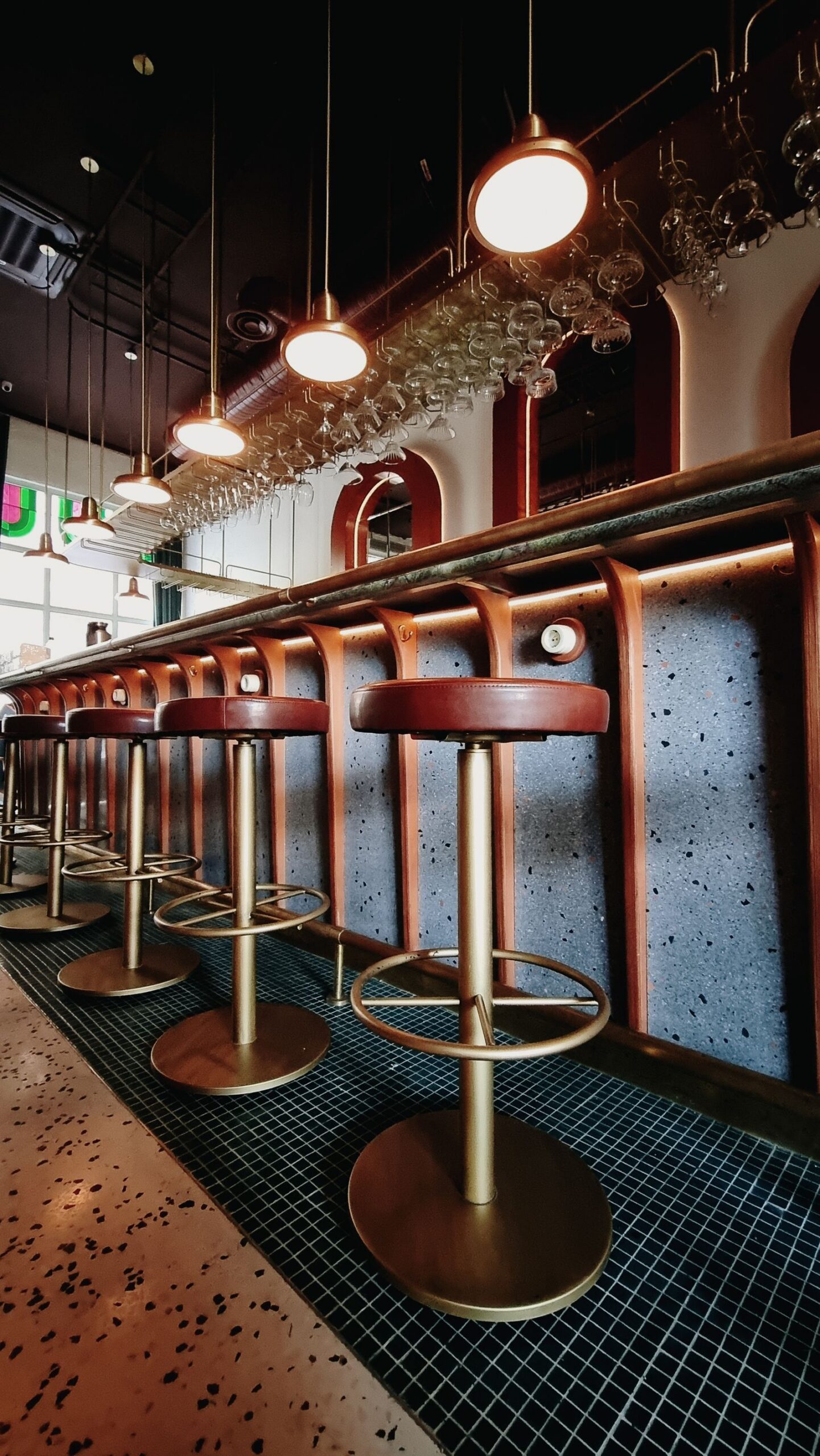 Bar counter with a row of leather stools
