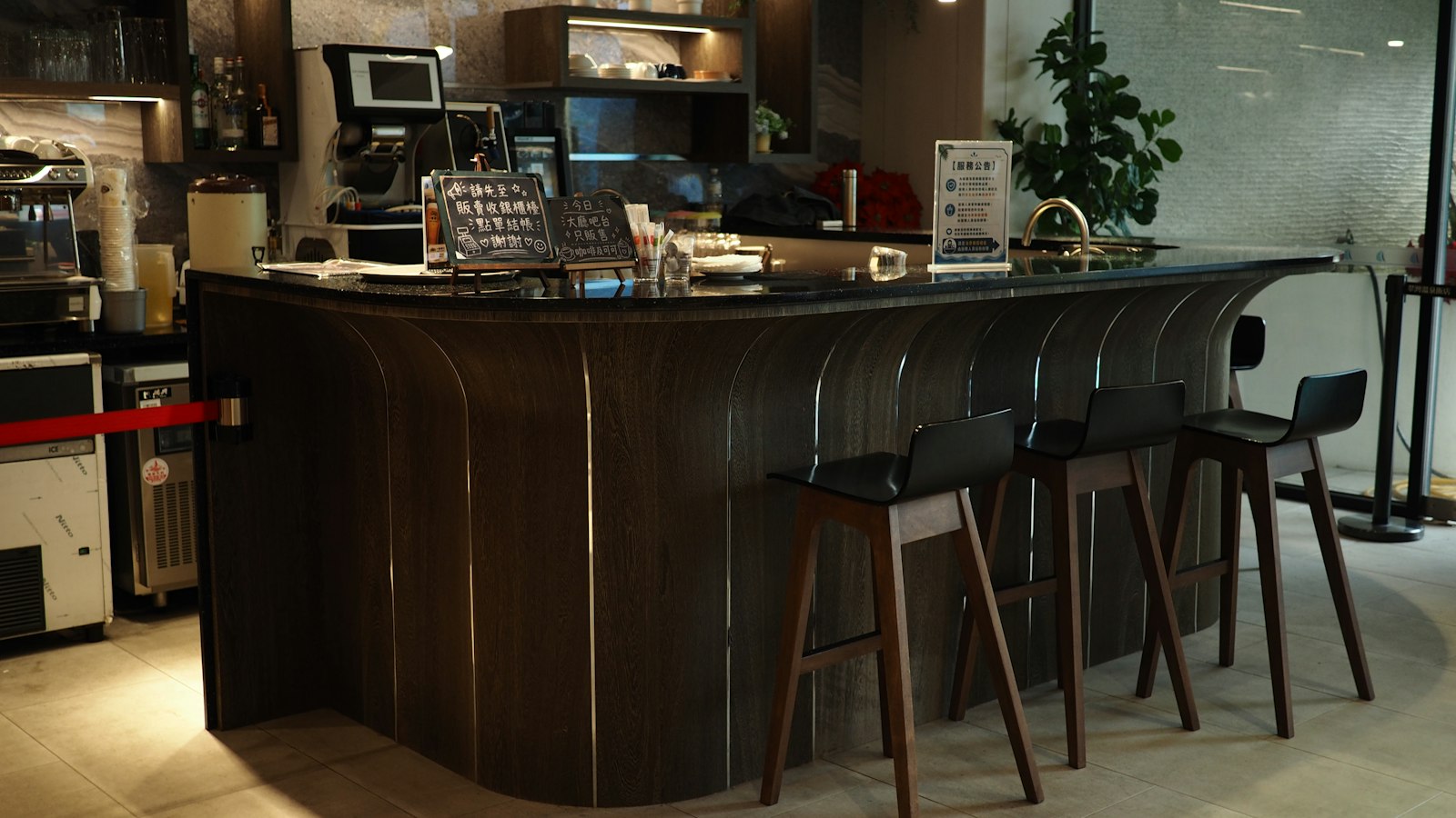 Curved wooden bar counter with bar stools