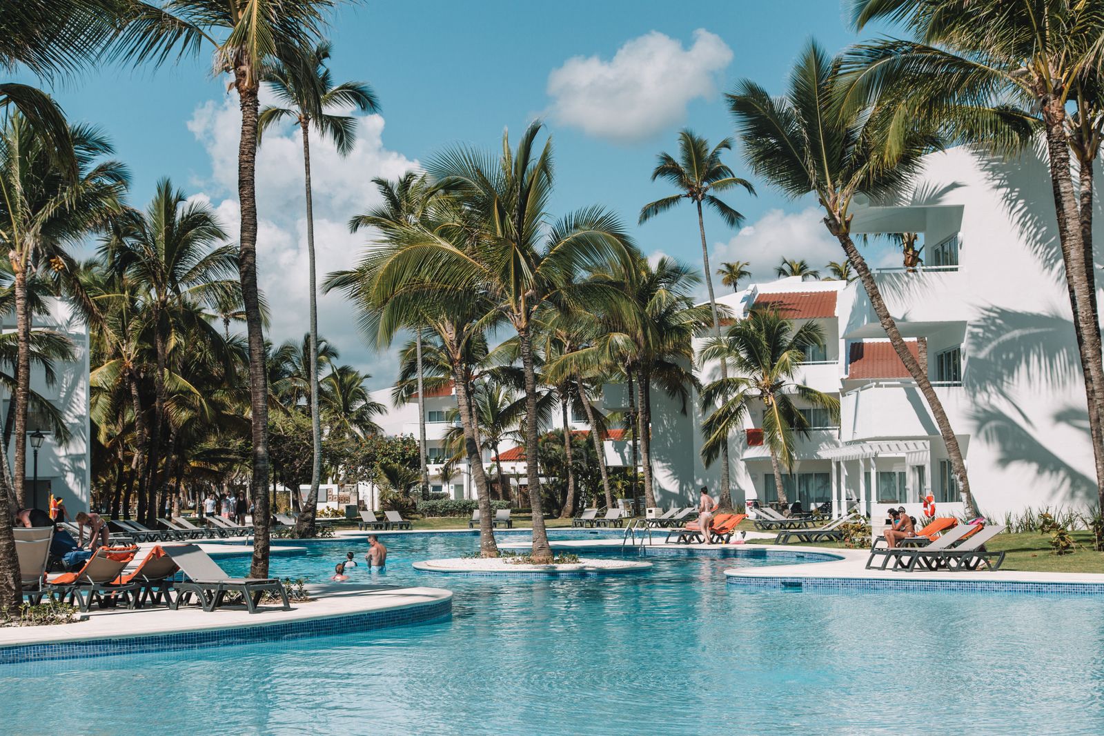 Resort pool surrounded by palm trees in Punta Cana, Dominican Republic